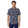 Men’s blue floral short sleeve shirt in cotton, navy ground with powder-blue hibiscus, grey monstera and yellow accents, soft collar, modern fit, worn untucked.